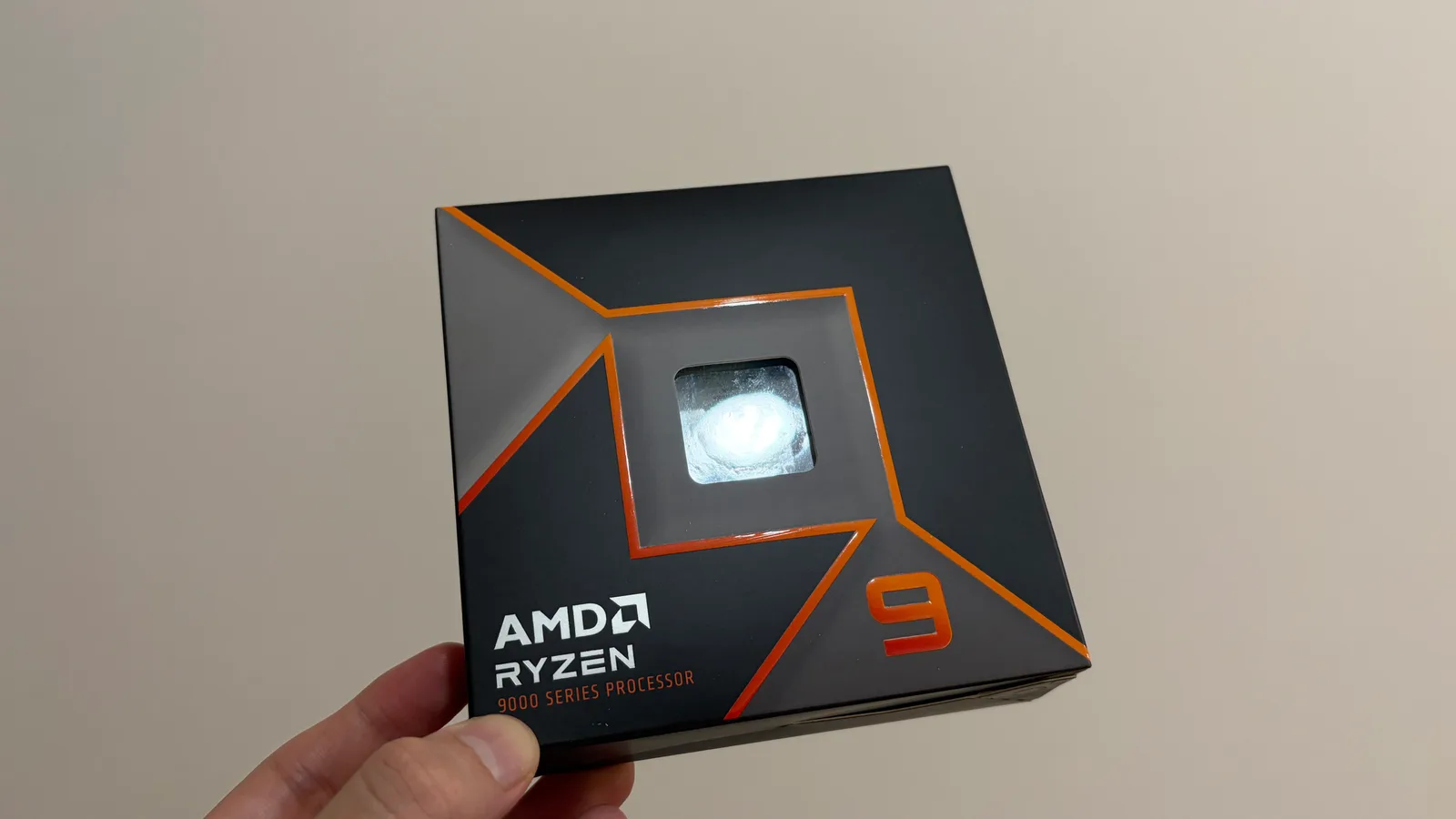 手に持ったAMD Ryzen 9 9950Xのパッケージ